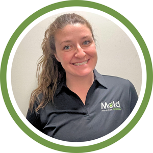 A person with long hair smiles while wearing a black polo shirt featuring a green and white logo. Against a plain background, the image is encircled by a green border, symbolizing an investigation into style and simplicity.