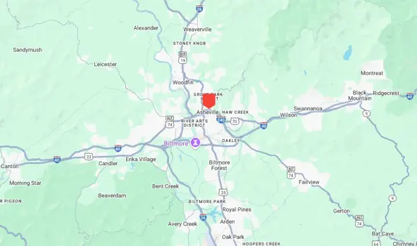 Map showing the Asheville area in North Carolina, highlighting Biltmore Village and nearby towns. Major roads, including I-26 and I-40, are marked for easy navigation during your mold investigation. Hilly terrain is depicted in green with a red marker at Asheville.