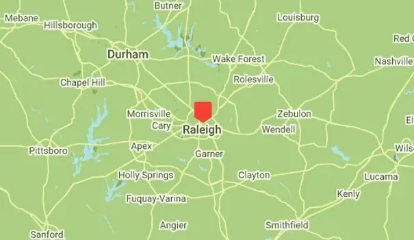 Map showing Raleigh, North Carolina, highlighted in red, surrounded by towns like Durham, Wake Forest, and Cary. Various highways and roads connect these locations on a green background. Ideal for planning your route to the best mold inspection or testing services in the area.
