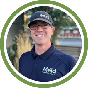 A man wearing glasses, a dark cap, and a navy blue polo shirt with the Mold Inspection Sciences logo smiles outdoors, ready for sampling and testing. The image is framed by a green and white circular border.