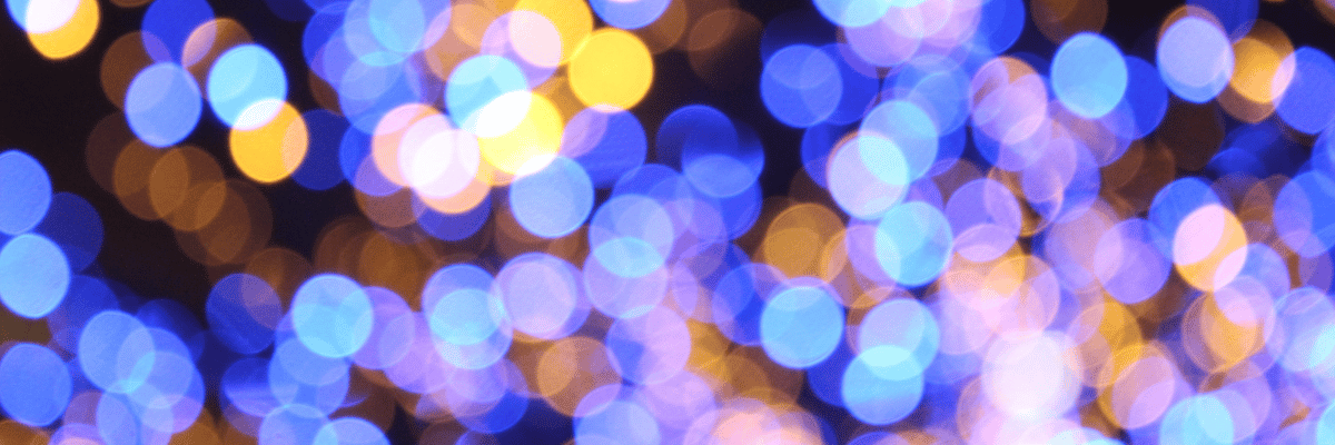 A blurred bokeh background with a mix of blue, purple, and orange circular lights creates a soft and abstract visual effect, reminiscent of an investigation into the mysteries of color and light.
