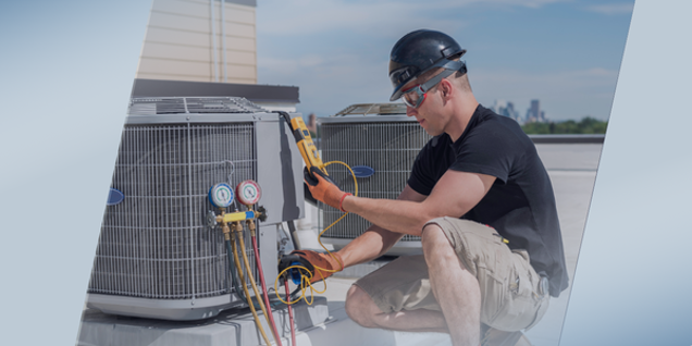 A technician wearing safety gear conducts a thorough inspection of an air conditioning unit on a rooftop using gauges and a digital meter, with buildings visible in the background.