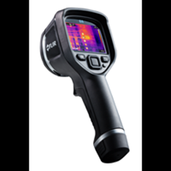 A handheld thermal imaging camera, essential for investigation, displays a thermal image on its screen. The device features a black, ergonomic grip with several buttons below the display for precise control and testing in various conditions.