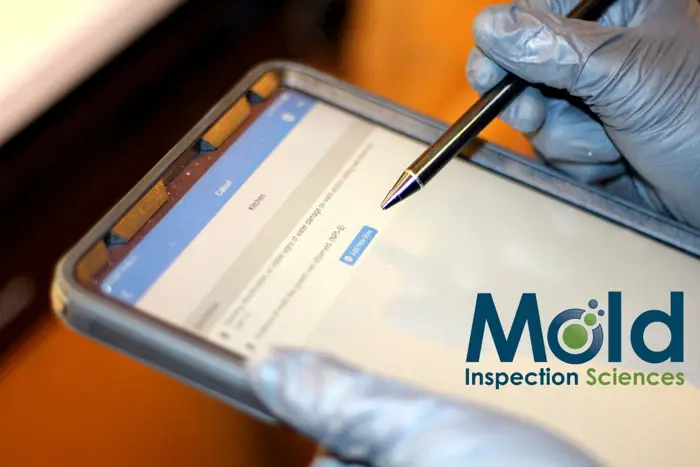 A person wearing gloves uses a stylus on a tablet screen displaying a form, conducting testing. The logo for Mold Inspection Sciences is visible on the right side of the image.