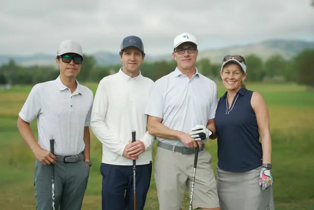 A group of four golfers at the Holes of Hope charity tournament.